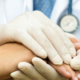 A doctor holding a patient's hand