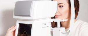 A woman with her face in an eye exam machine