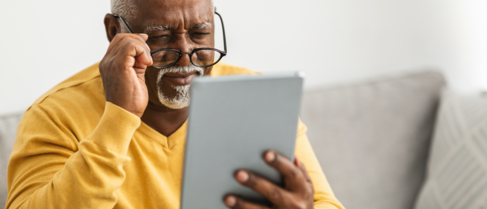 man unable to read his tablet because of vision issues