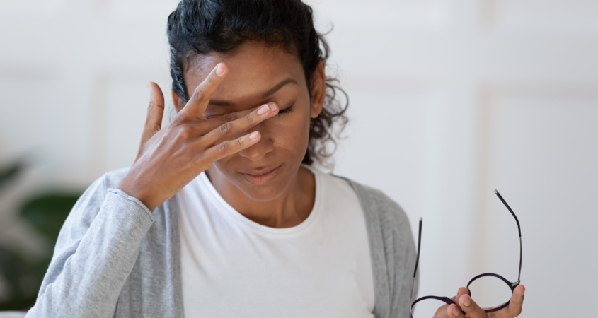 Head shot young stressed unhappy african american woman taking off eyeglasses, feeling tired of long computer work or suffering from dry eyes syndrome, massaging nose bridge, relieving pain.