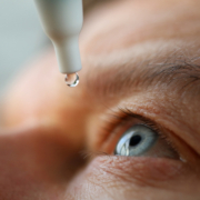 Man drops eye drops install lenses, moisturizing. Preservation and solution vision problems. Eye diseases are recognized. Drops before putting on lenses or before removing at end day