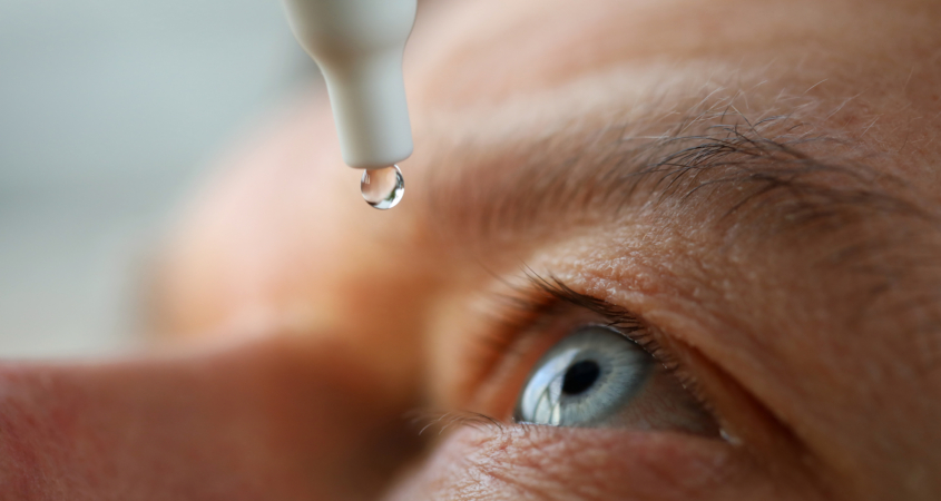 Man drops eye drops install lenses, moisturizing. Preservation and solution vision problems. Eye diseases are recognized. Drops before putting on lenses or before removing at end day