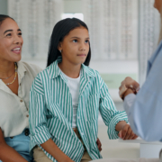 Image of a mom taking her daughter to get an exam exam in the event of hereditary glaucoma.
