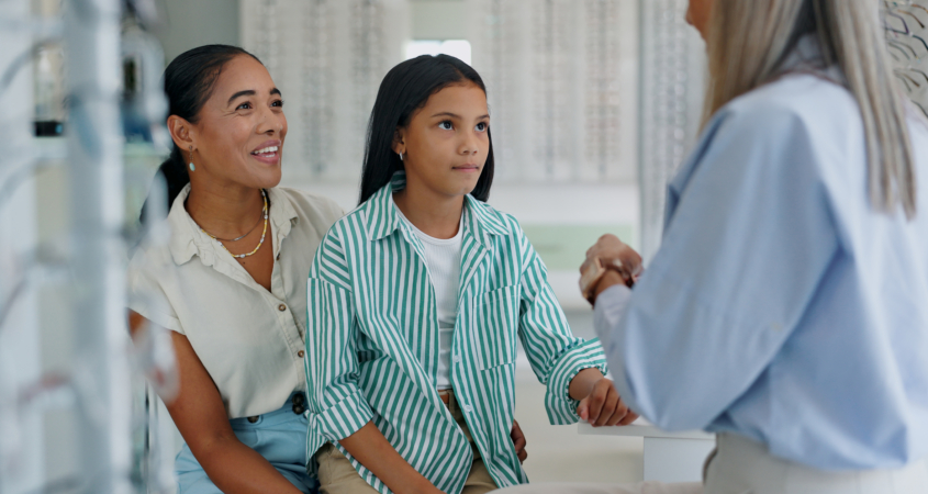Image of a mom taking her daughter to get an exam exam in the event of hereditary glaucoma.