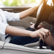 Image of a woman changing gears in her car.