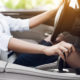Image of a woman changing gears in her car.