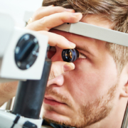 Image of a younger man doing a vision exam.