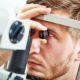 Image of a younger man doing a vision exam.