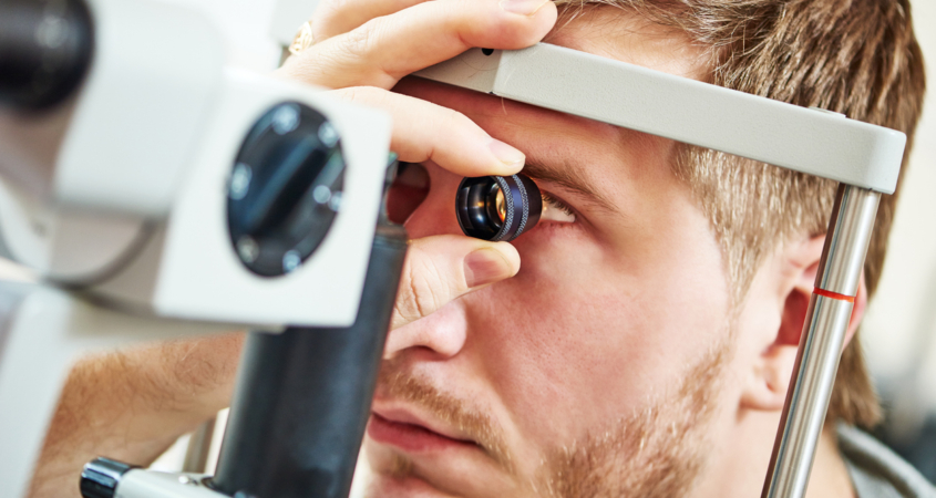 Image of a younger man doing a vision exam.