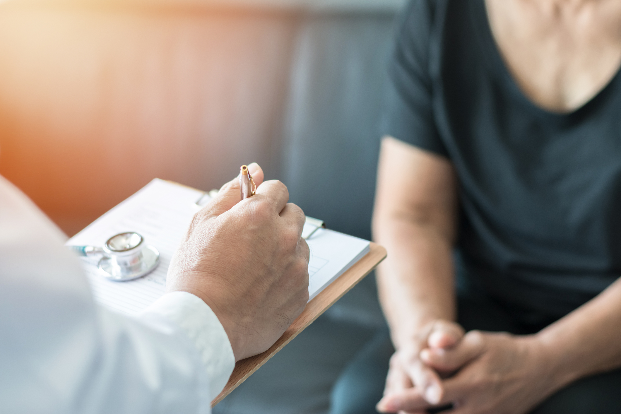 Image of a doctor going over their patients' charts.