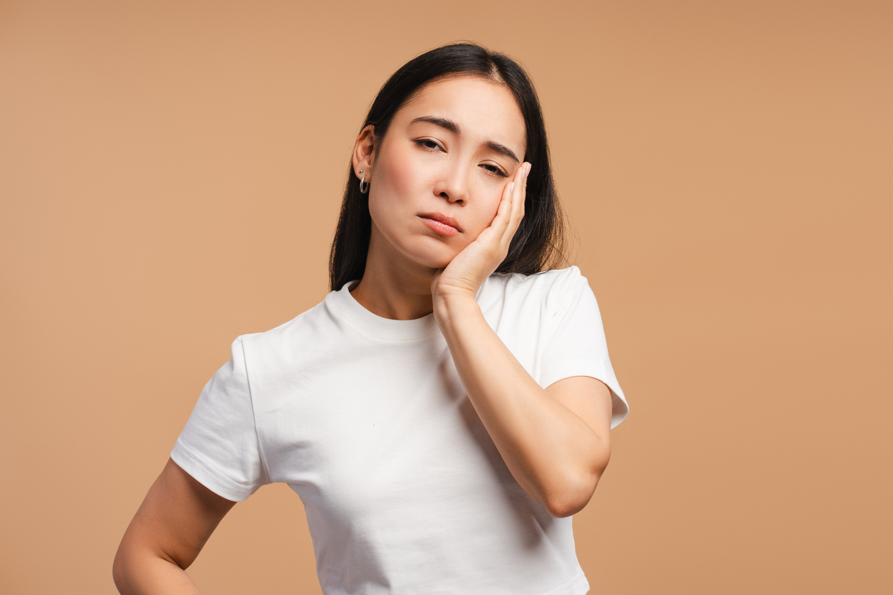 woman holding side of face