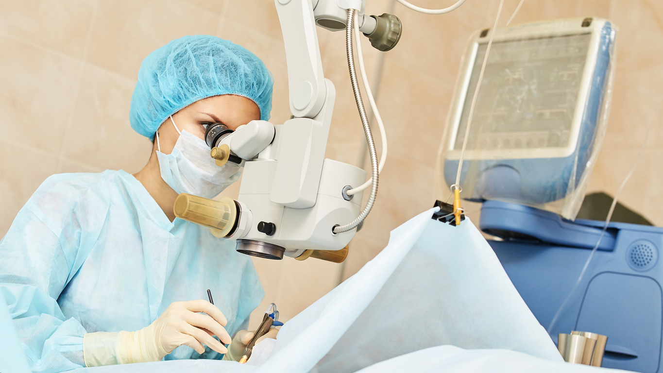 woman performing eye surgery