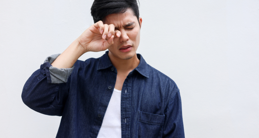 Man scratching his eye