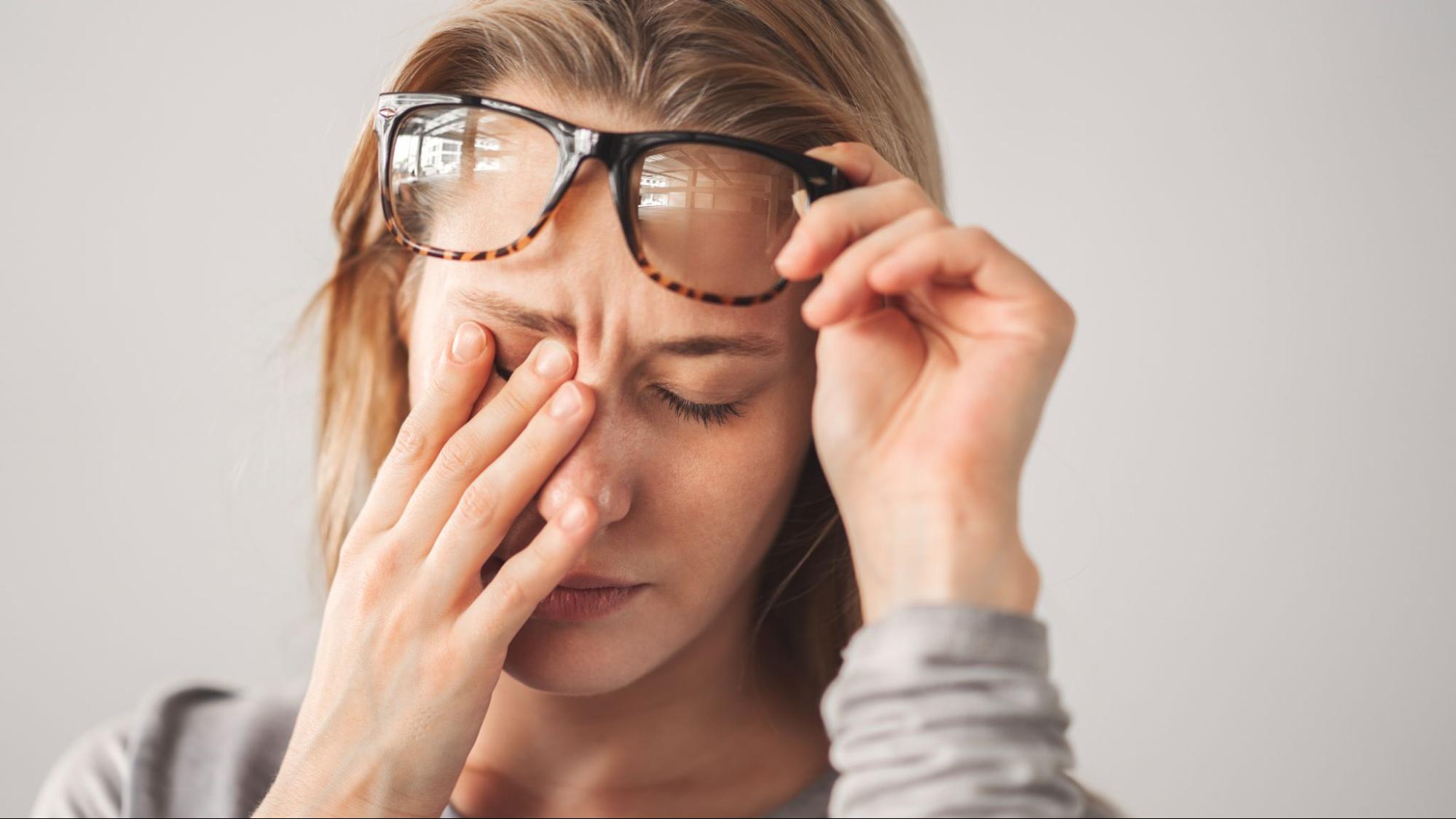 woman rubbing eyes