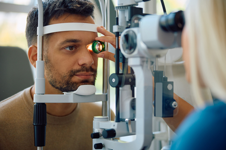 Young man during eye vision check at ophthalmology clinic