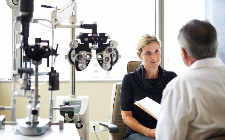 A woman listens to her opthamologist